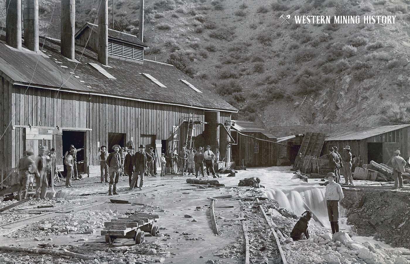 Miners watch water pour out of the Clifton Tunnel - Austin Nevada 1896