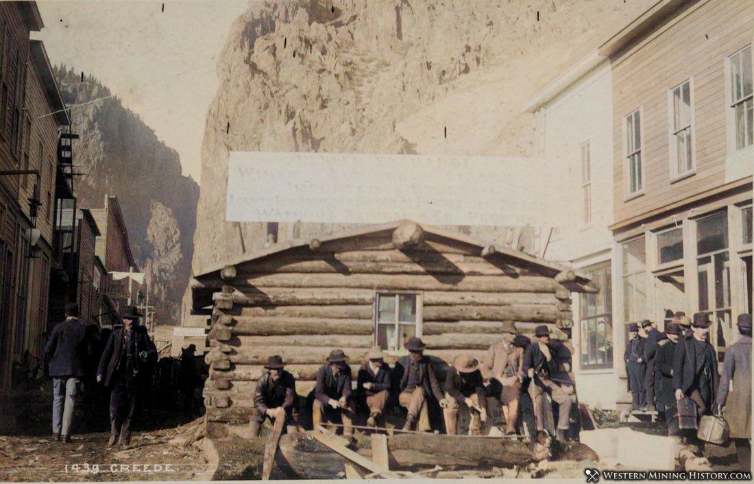 View of log cabin being consumed by progress at Creede, Colorado (colorized)