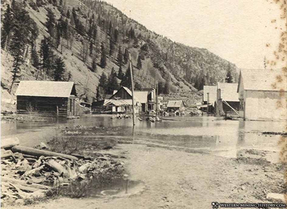 Rising waters of Monumental Creek slowly submerging Roosevelt, Idaho 1909