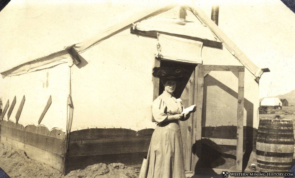 Woman stands in front of canvas-sided home