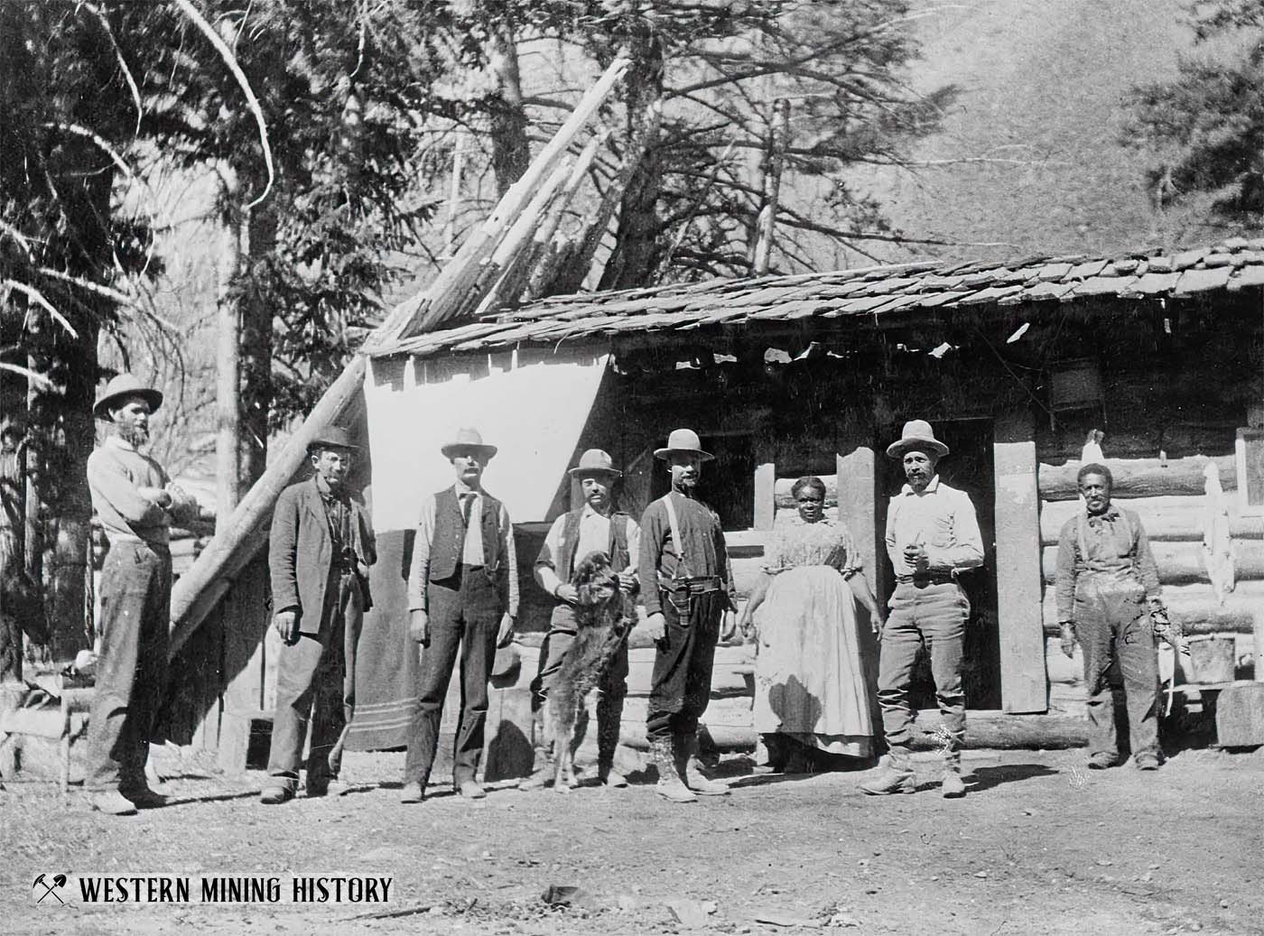 Early residents of Thunder Mountain, Idaho pose with dog 1904