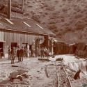 Miners watch water pour out of the Clifton Tunnel - Austin Nevada 1896