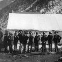 Men pose in front of a Copper Rock business housed in a canvas tent 1892