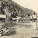 Rising waters of Monumental Creek slowly submerging Roosevelt, Idaho 1909