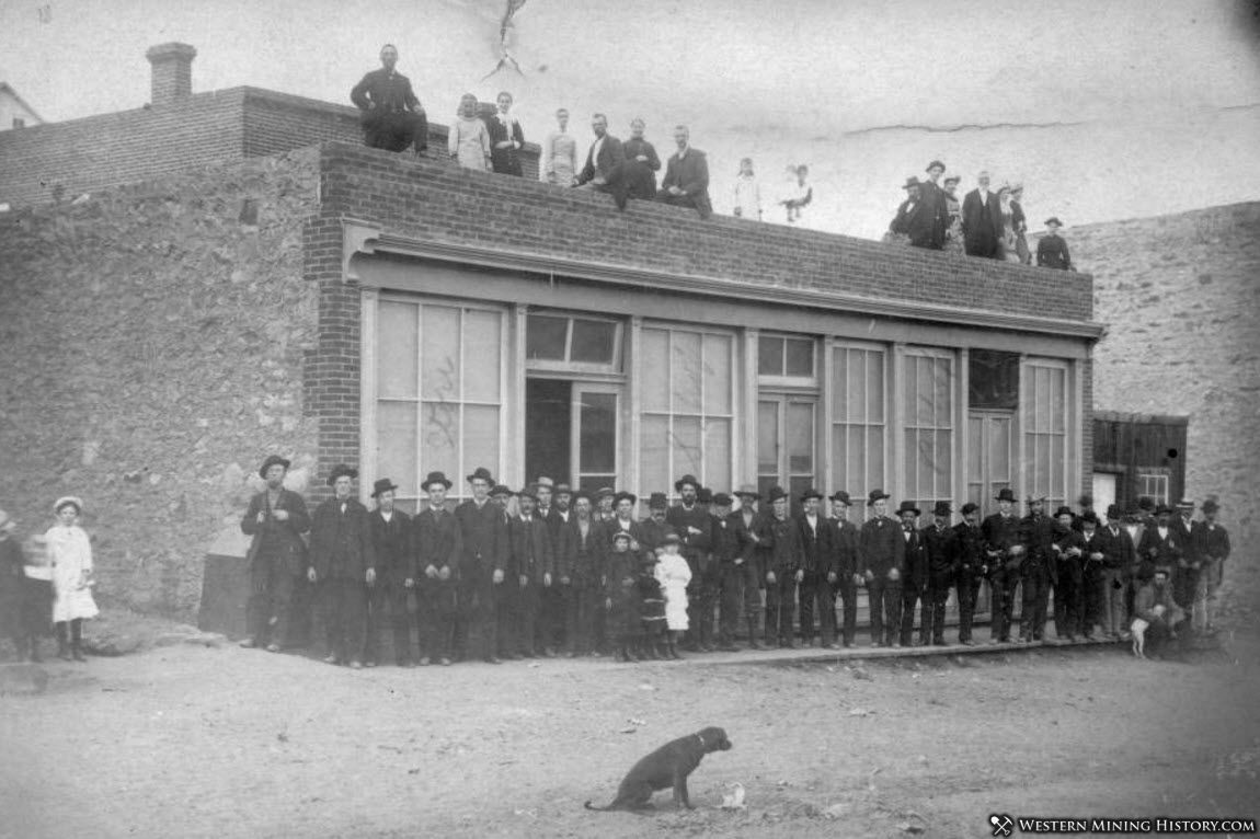 Citizens of Nevadaville Colorado pose in front of a commercial building 1883